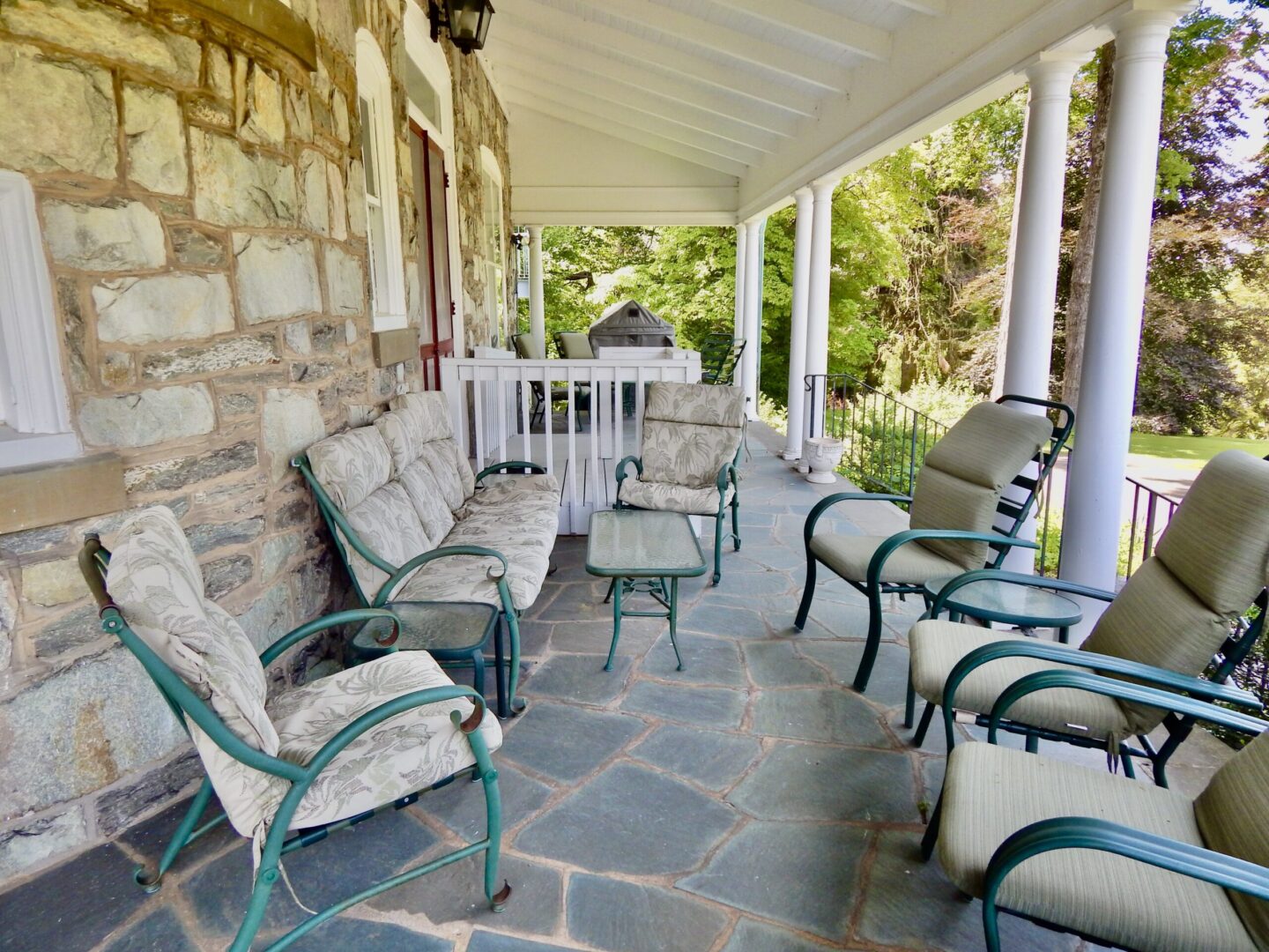 Main House porch with chairs and sofa