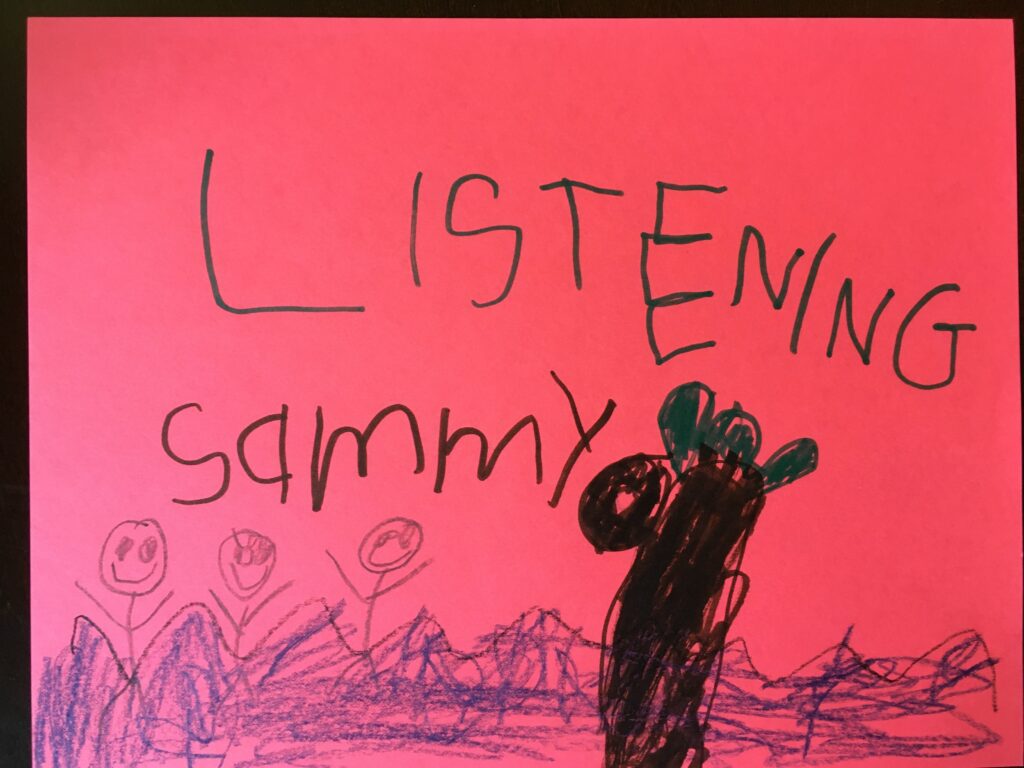 A child 's drawing of a person with headphones on.