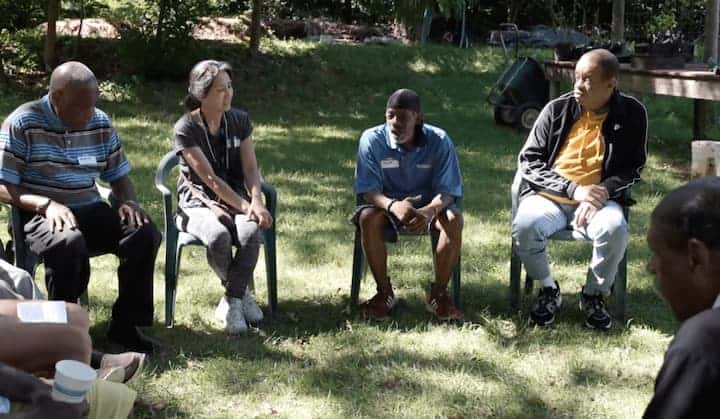 CATCH doing a group reflection outside in a circle after working in the garden.