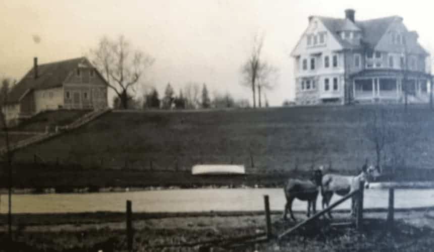 An old photo of Cranaleith in black and white with horses where the pond is.