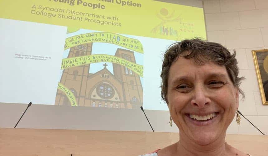 Bernadette Rudolph smiling in Rome during a presentation.