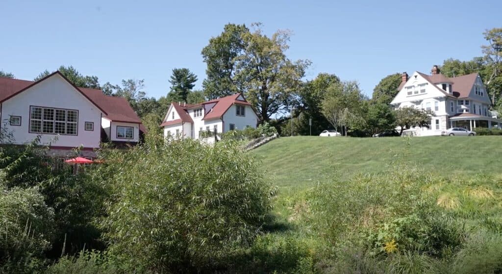 Education & Conference Center, Administration Building, and Historic House surrounded by green trees.