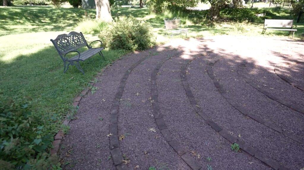 The brick labyrinth, with a bench.