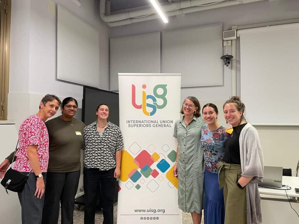 Bernadette Rudolph, Maureen O'Connell, and their group taking a picture at the International Union Superiors General in Rome, Italy.