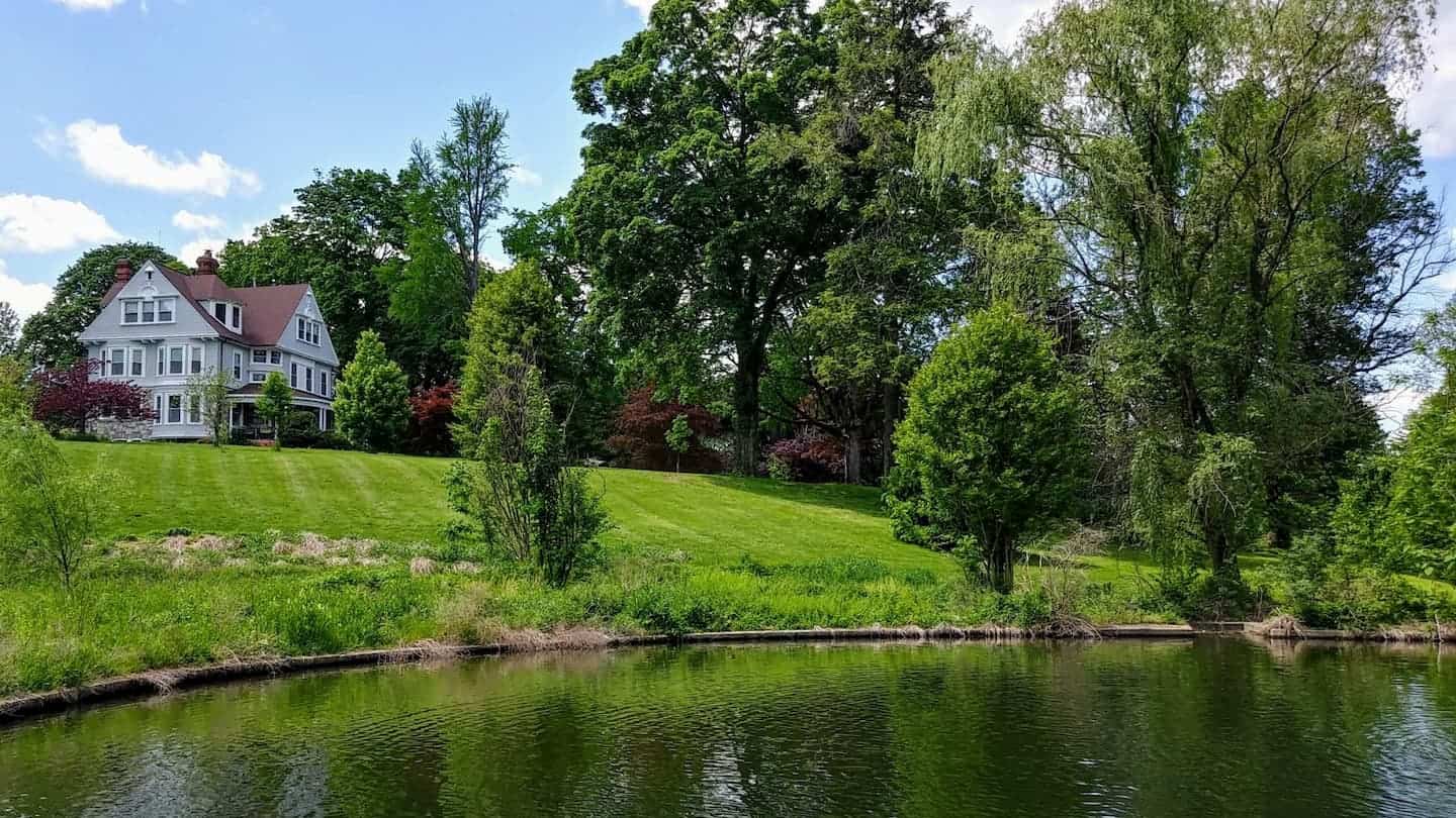 Cranaleith's grounds, highlighting the trees and historic house, taken from the fountain.