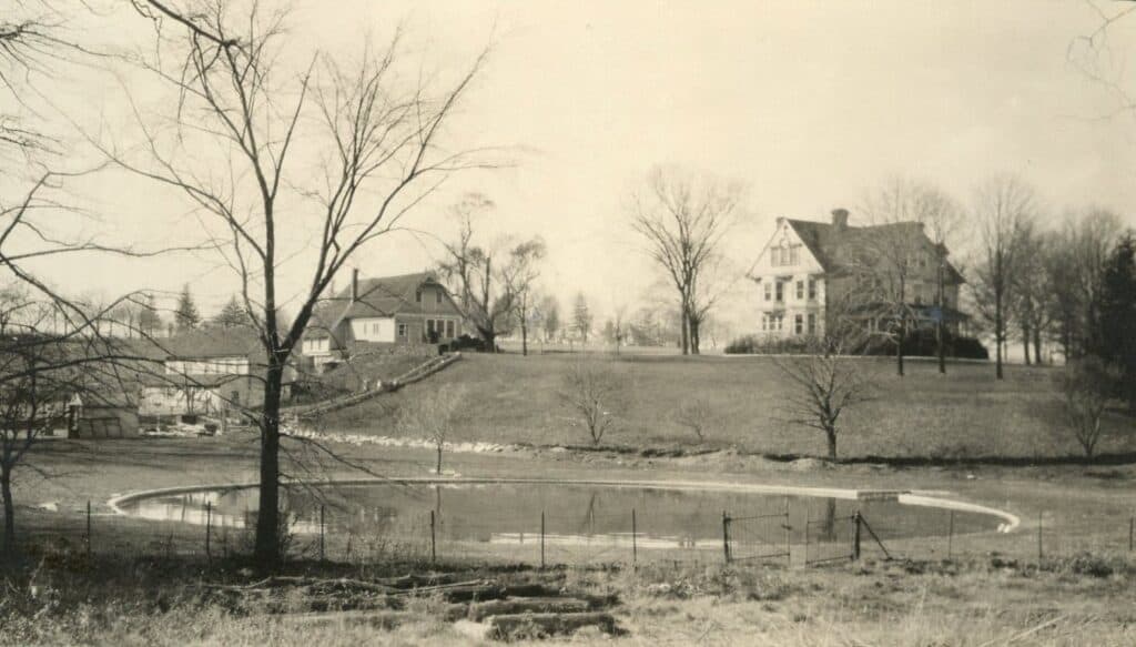 A vintage photo of Cranaleith, showing the fountain, historic house, and other buildings which ended up becoming the Administration building and Conference Center.