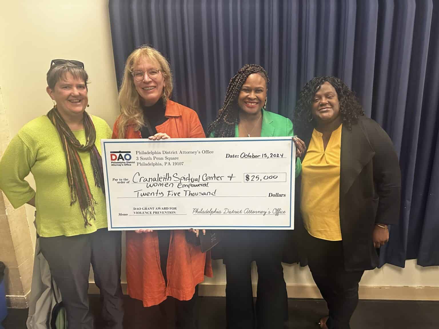 Four women including Cranaleith's Executive Director, Program Director, and facilitator/partner accepting a $25,000 grant for programming targeted toward empowering women.